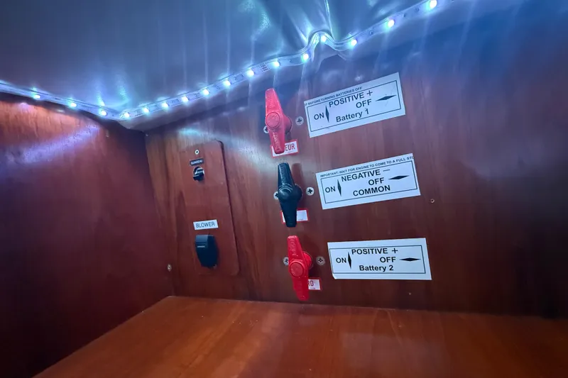 Slide: The Image of Electrical panel of 2003 Jeanneau Sun Odyssey 37 with battery switches and labels. - 80
