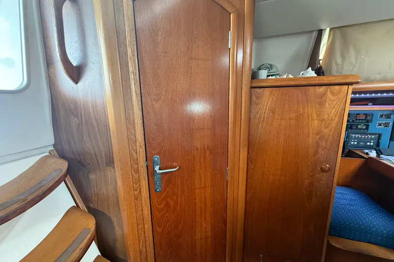 Slide: The Image of Interior of 2003 Jeanneau Sun Odyssey 37 sailboat, featuring wooden cabinetry and seating. - 82
