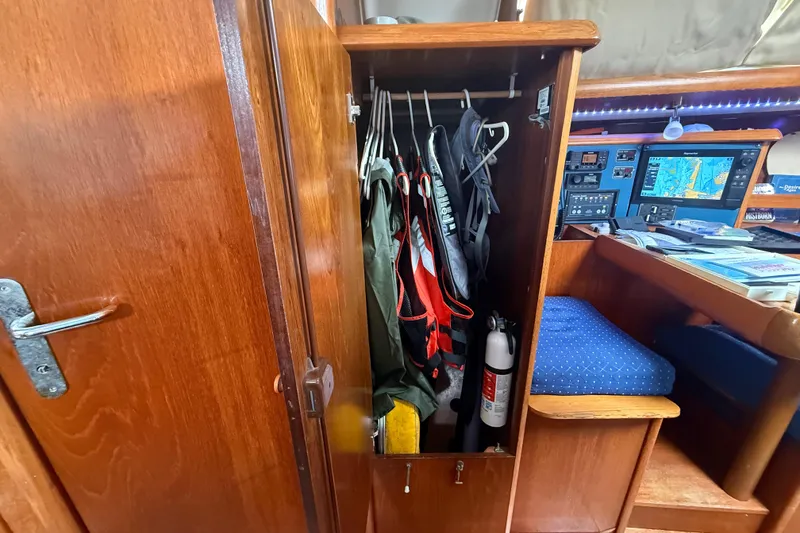 Slide: The Image of Interior of 2003 Jeanneau Sun Odyssey 37 sailboat with closet and navigation station. - 83