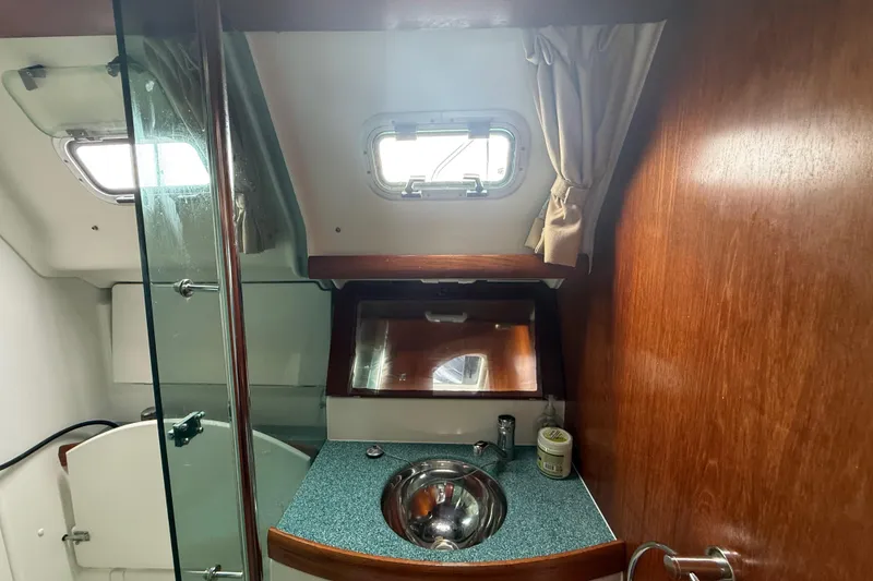 Slide: The Image of Bathroom interior of 2003 Jeanneau Sun Odyssey 37 yacht with sink and window. - 85