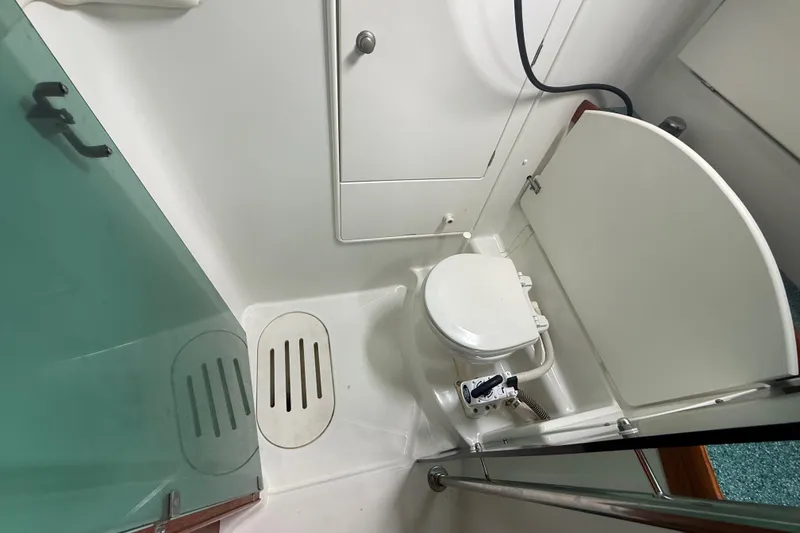 Slide: The Image of Bathroom interior of 2003 Jeanneau Sun Odyssey 37 yacht, featuring toilet and shower area. - 86
