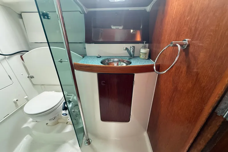 Slide: The Image of Bathroom interior of 2003 Jeanneau Sun Odyssey 37 yacht, featuring sink and toilet. - 87