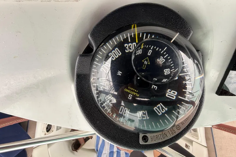 Slide: The Image of Compass on Jeanneau Sun Odyssey 37 yacht, model year 2003, showing navigation directions. - 95