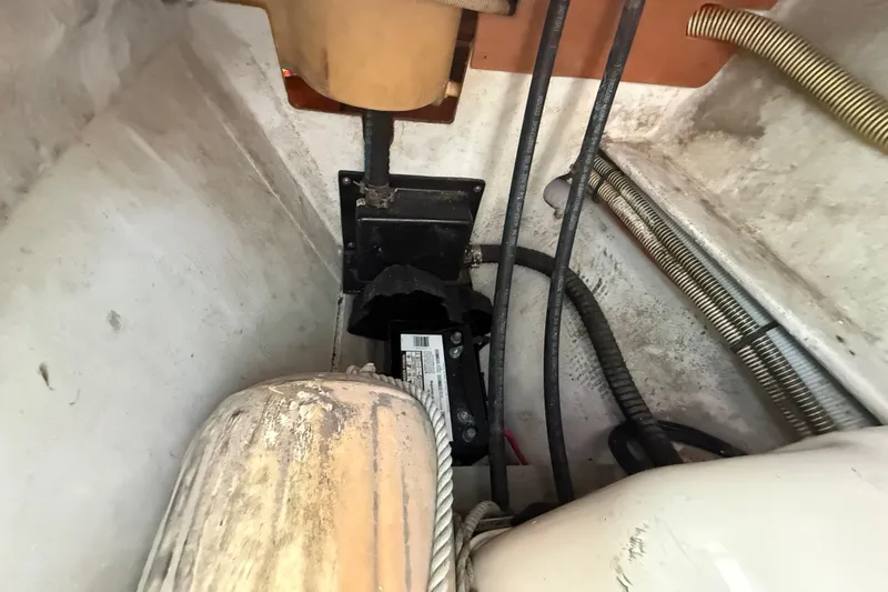 Slide: The Image of Engine compartment of a 2003 Jeanneau Sun Odyssey 37 sailboat, showing cables and components. - 96