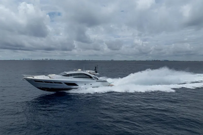 Slide: The Image of 2020 Pershing 8X yacht cruising on open sea under cloudy skies. - 14