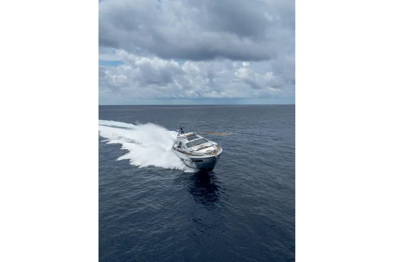 Slide: The Image of 2020 Pershing 8X yacht cruising on open sea under cloudy skies. - 16