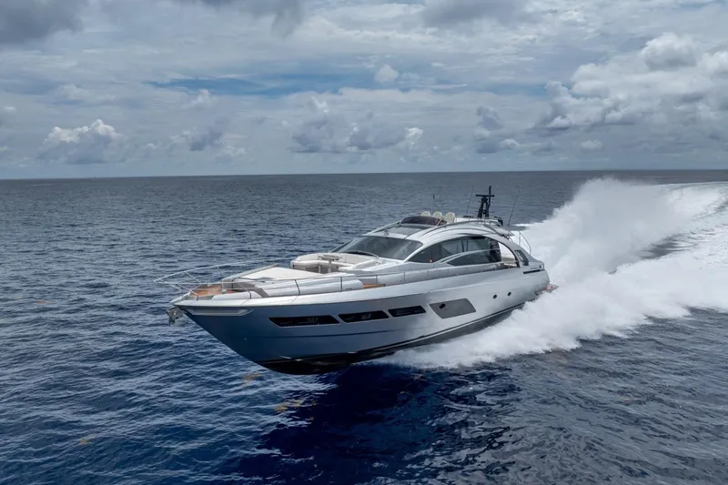 Slide: The Image of 2020 Pershing 8X yacht cruising swiftly on open ocean under cloudy skies. - 19