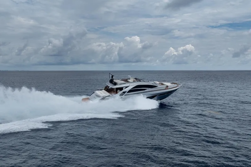 Slide: The Image of 2020 Pershing 8X yacht cruising swiftly on open ocean under cloudy skies. - 21