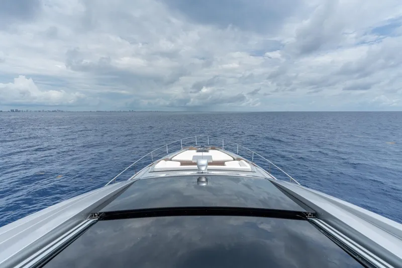 Slide: The Image of Bow view of 2020 Pershing 8X yacht cruising on open sea under cloudy sky. - 25