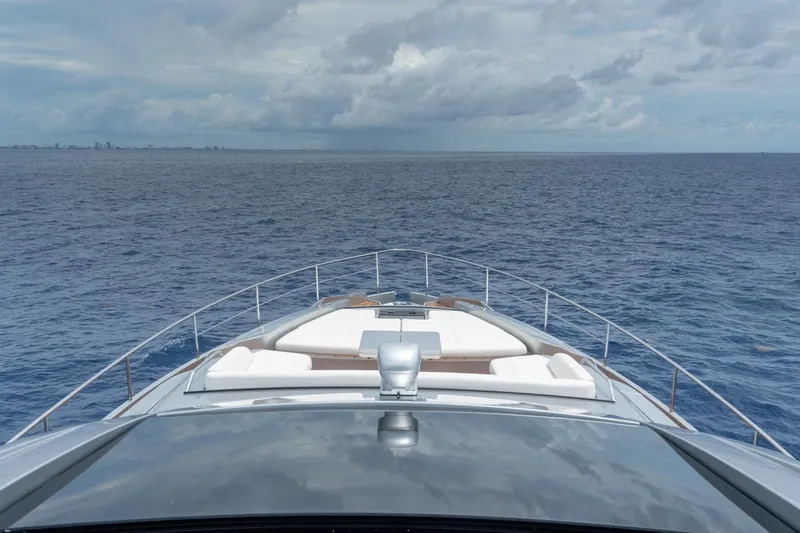 Slide: The Image of Bow view of 2020 Pershing 8X yacht cruising on open sea under cloudy skies. - 26