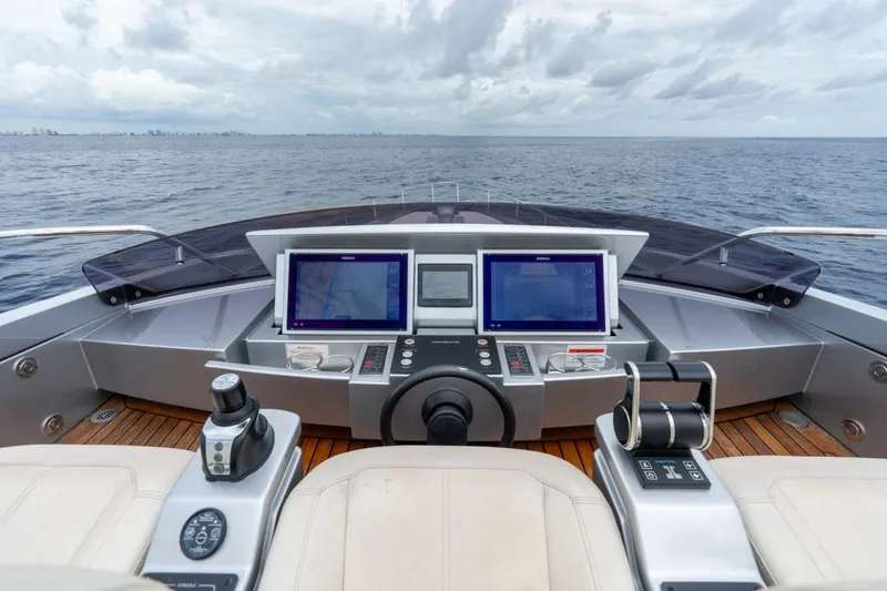 Slide: The Image of Cockpit view of 2020 Pershing 8X yacht with dual navigation screens and ocean backdrop. - 27