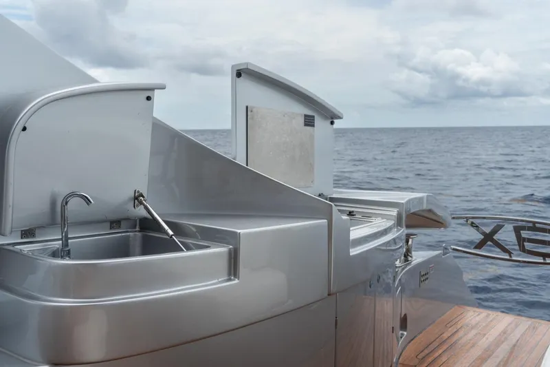 Slide: The Image of Luxury Pershing 8X yacht kitchen area with ocean view, featuring sleek stainless steel sink. - 38