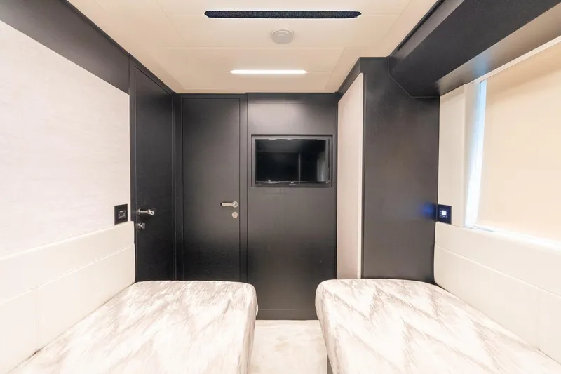 Slide: The Image of Luxurious interior of 2020 Pershing 8X yacht with twin beds and modern decor. - 51
