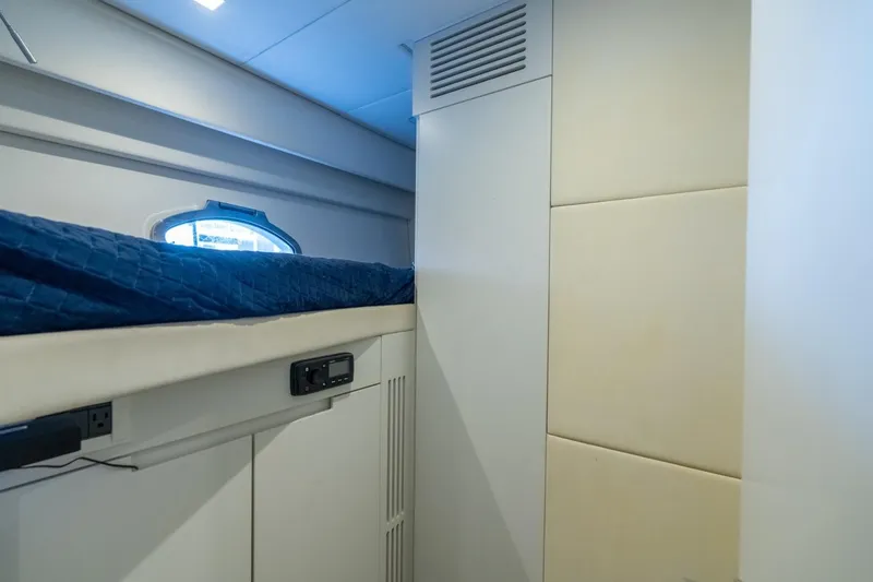 Slide: The Image of Interior cabin of 2020 Pershing 8X yacht with blue bedding and modern design. - 60