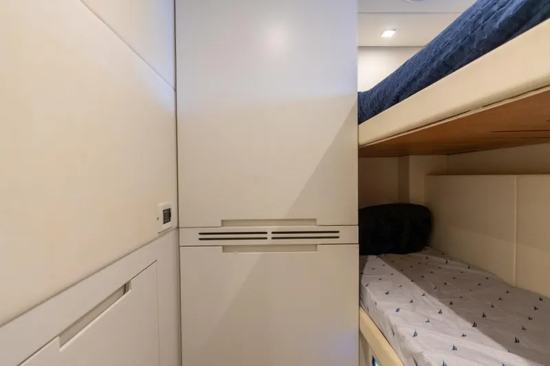 Slide: The Image of Interior of 2020 Pershing 8X yacht featuring modern bunk beds and sleek design. - 62