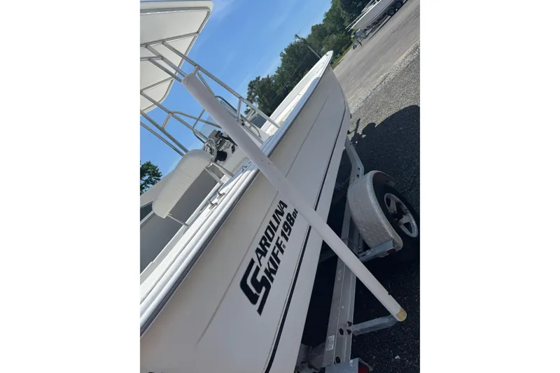 Slide: The Image of 2010 Carolina Skiff 198 DLV boat on trailer in outdoor setting. - 6