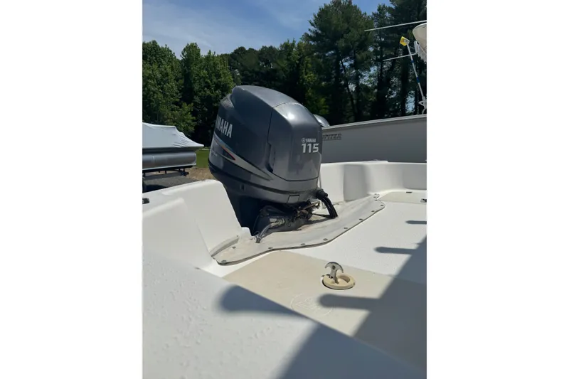 Slide: The Image of 2010 Carolina Skiff 198 DLV boat with Yamaha 115 outboard motor in a wooded area. - 7