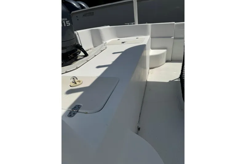 Slide: The Image of 2010 Carolina Skiff 198 DLV boat interior with Yamaha motor, showcasing seating and storage. - 8