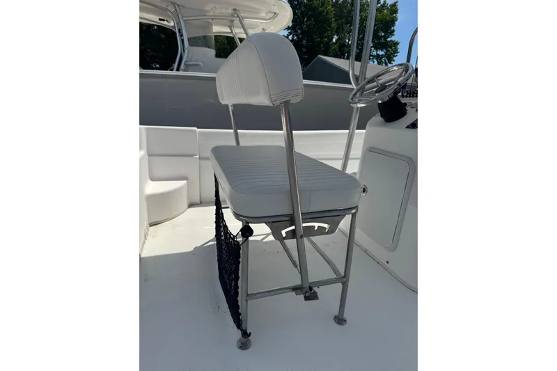 Slide: The Image of 2010 Carolina Skiff 198 DLV boat interior with white seating and steering console. - 9