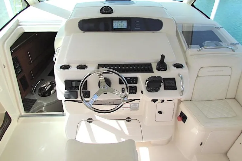 Slide: The Image of Helm of 2019 Grady-White Express 370 boat with modern controls and seating. - 10