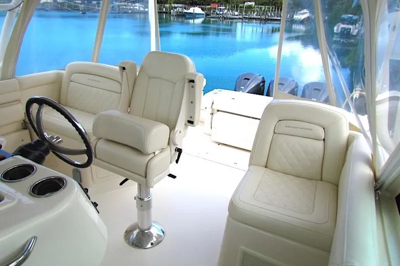 Slide: The Image of 2019 Grady-White Express 370 boat interior with luxurious seating and steering wheel. - 13