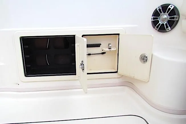 Slide: The Image of 2019 Grady-White Express 370 boat storage compartment with open doors and speaker. - 16