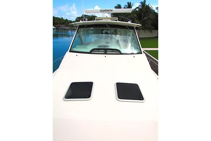 Slide: The Image of 2019 Grady-White Express 370 boat with Garmin radar, docked by lush greenery. - 19