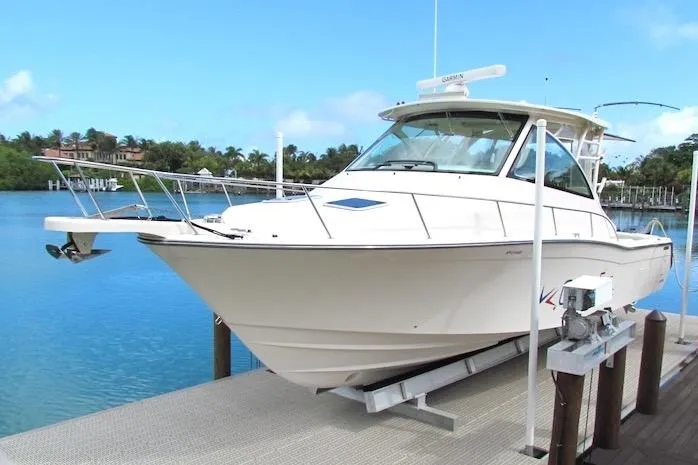 Slide: The Image of 2019 Grady-White Express 370 boat docked by serene blue waters. - 2