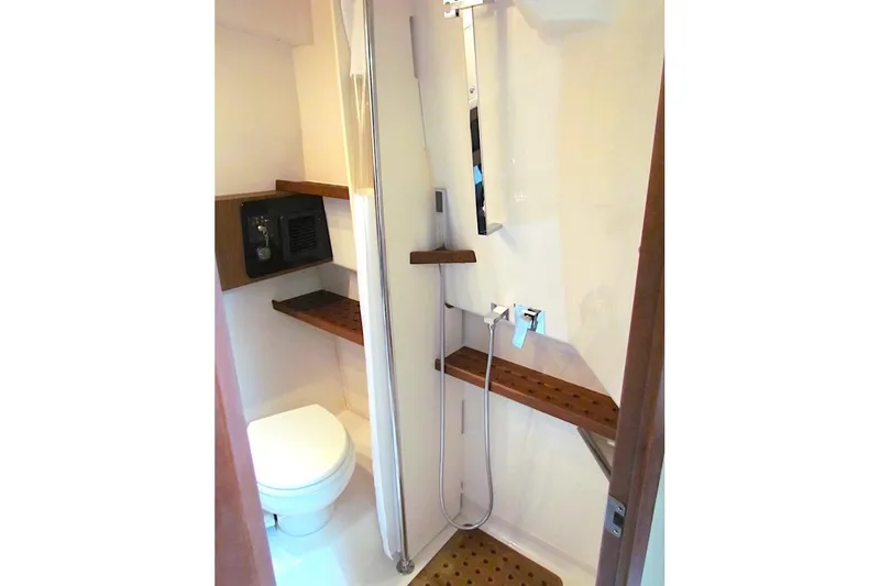 Slide: The Image of Bathroom interior of 2019 Grady-White Express 370 boat, featuring shower and toilet. - 28