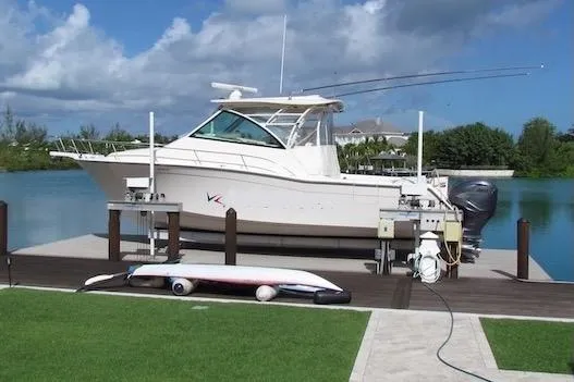 Slide: The Image of 2019 Grady-White Express 370 boat docked by a serene waterfront. - 3