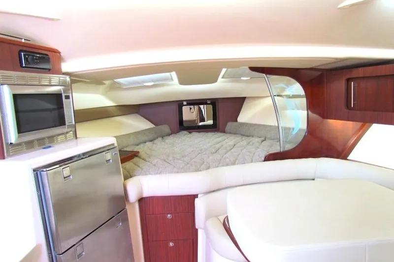 Slide: The Image of 2019 Grady-White Express 370 cabin interior with bed, microwave, and fridge. - 31