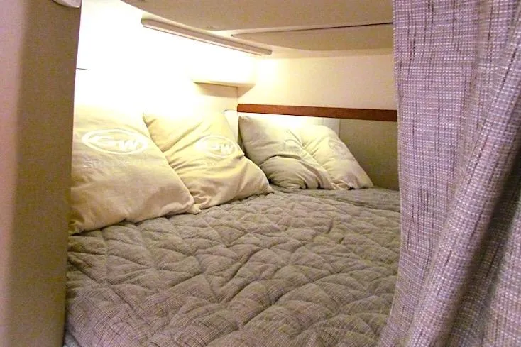 Slide: The Image of Cozy cabin bed in 2019 Grady-White Express 370 boat with pillows and soft lighting. - 33