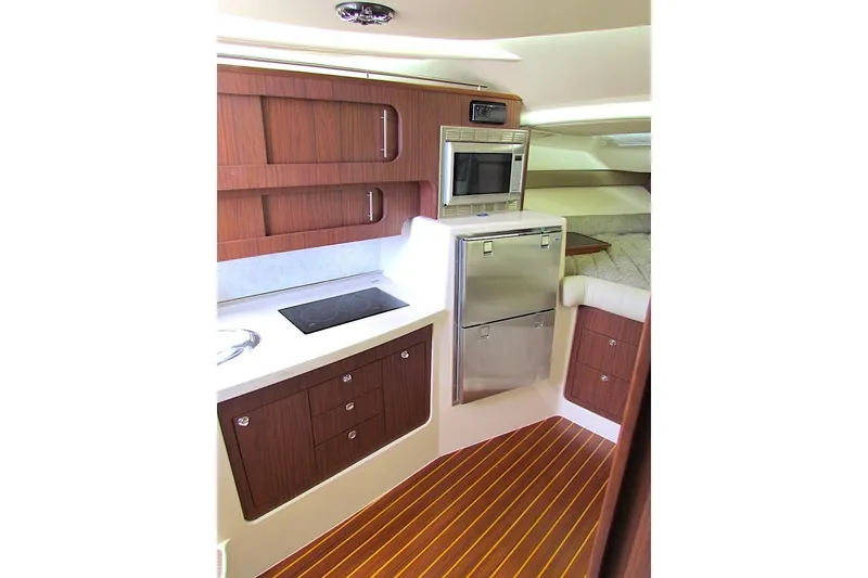 Slide: The Image of 2019 Grady-White Express 370 yacht interior kitchen with wood cabinetry and modern appliances. - 37