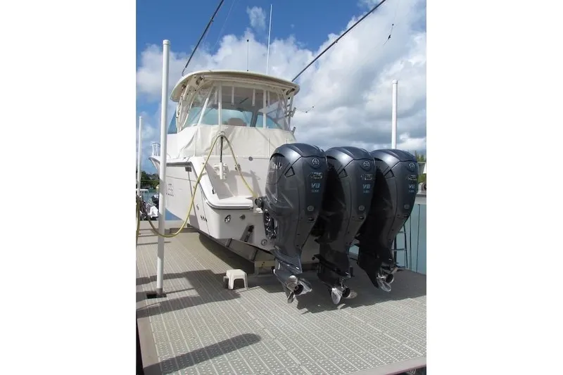 Slide: The Image of 2019 Grady-White Express 370 boat with triple outboard engines docked. - 4