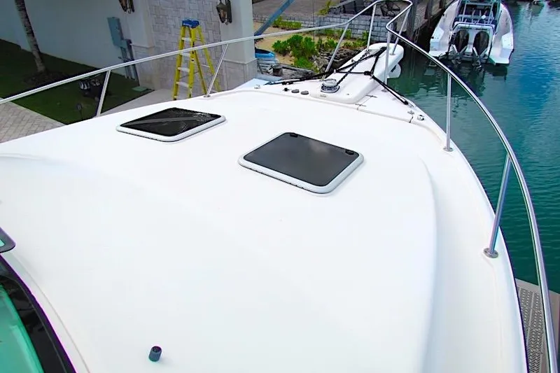Slide: The Image of 2019 Grady-White Express 370 boat deck with hatches, docked near water. - 7