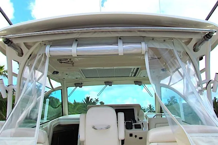 Slide: The Image of 2019 Grady-White Express 370 boat interior with clear curtains and seating. - 8