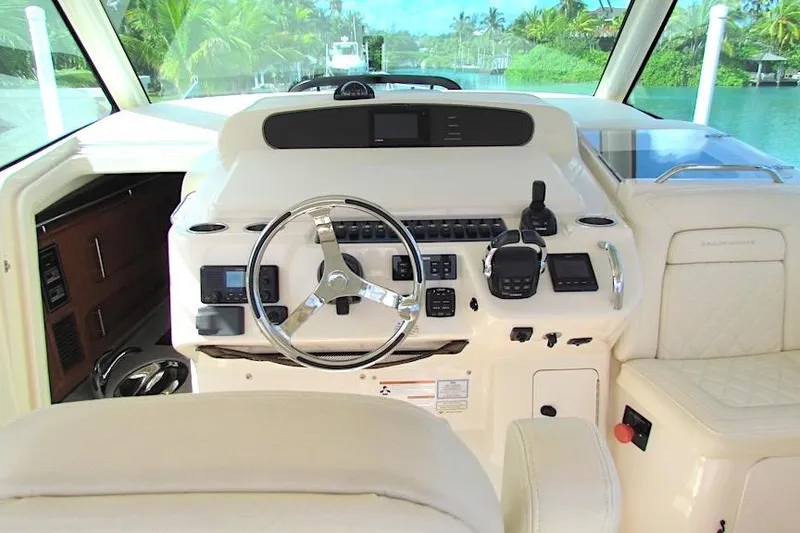 Slide: The Image of 2019 Grady-White Express 370 helm with steering wheel and navigation controls. - 9