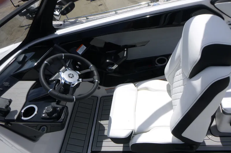Slide: The Image of 2026 Yamaha Boats 222S cockpit with sleek steering wheel and comfortable white seating. - 12