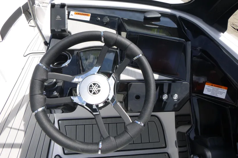 Slide: The Image of Steering wheel and dashboard of 2026 Yamaha Boats 222S, featuring modern controls and sleek design. - 13