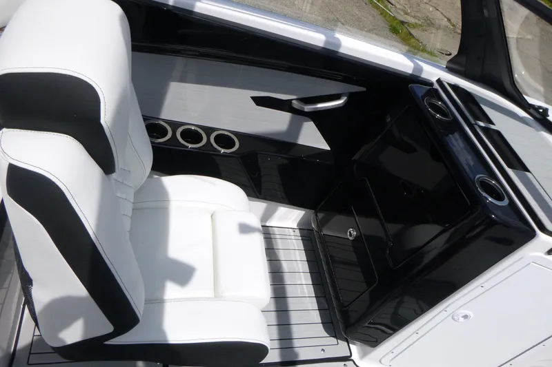 Slide: The Image of 2026 Yamaha Boats 222S interior with white seating and sleek black console design. - 14