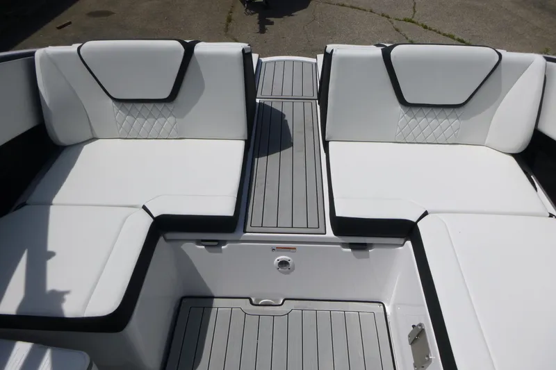 Slide: The Image of 2026 Yamaha Boats 222S interior with white cushioned seating and sleek gray flooring. - 15