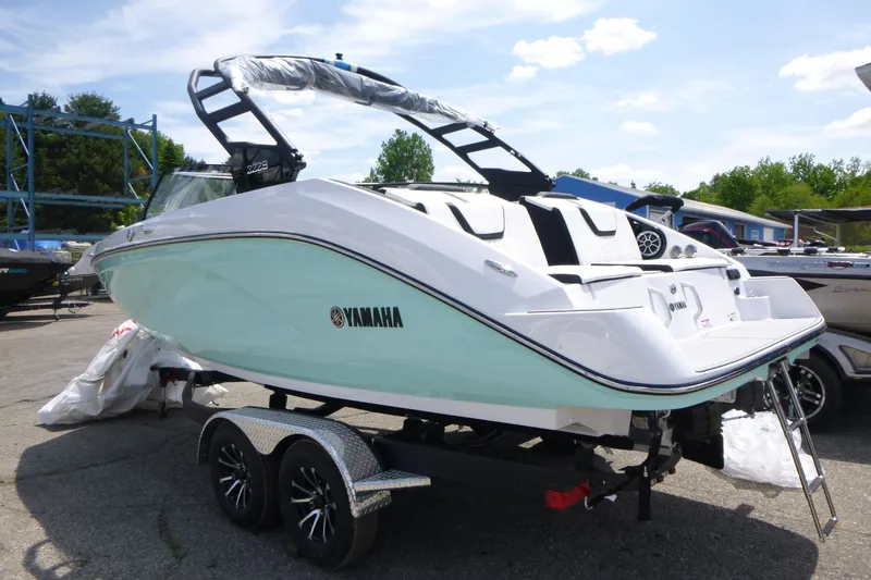 Slide: The Image of 2026 Yamaha Boats 222S on trailer, sleek design, mint green hull, outdoor display. - 2