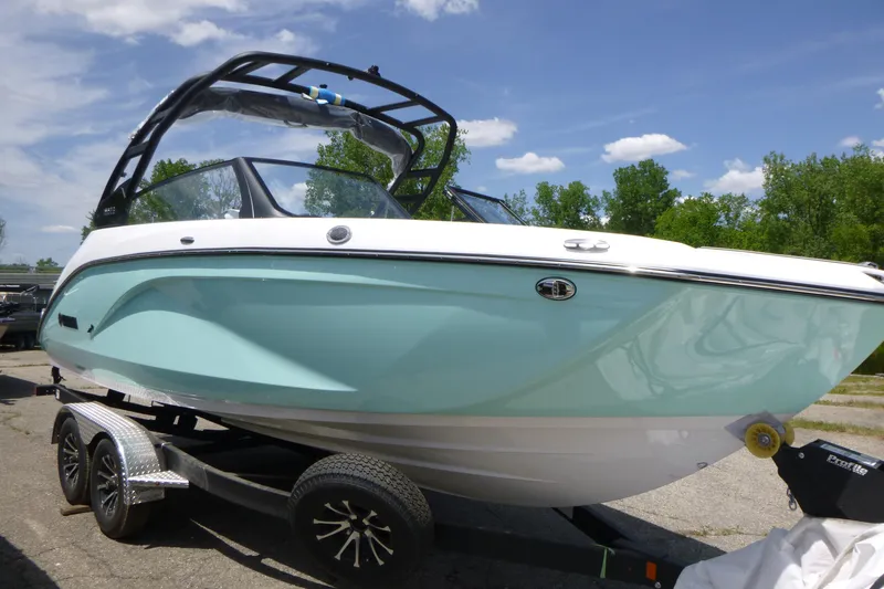 Slide: The Image of 2026 Yamaha Boats 222S on trailer, sleek design, light blue hull, sunny day. - 3