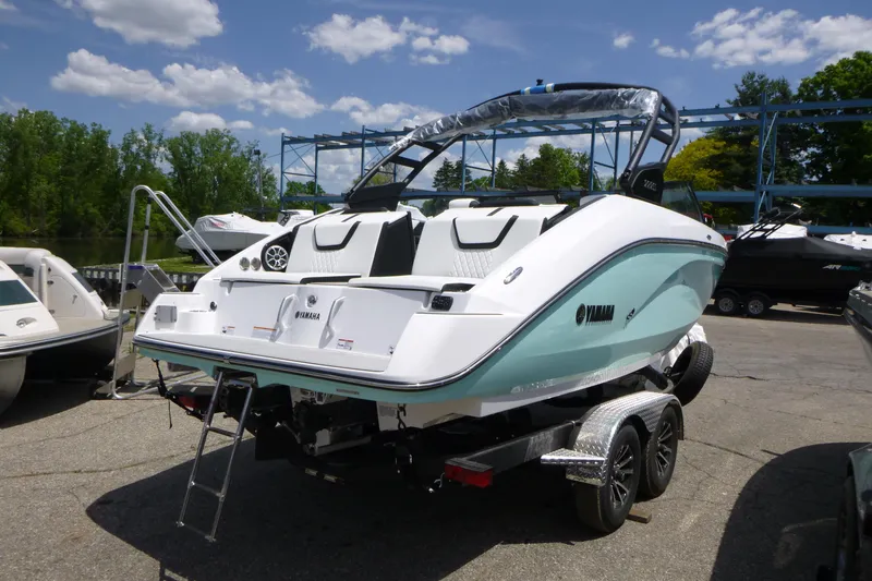 Slide: The Image of 2026 Yamaha Boats 222S on trailer, parked outdoors under a clear blue sky. - 4
