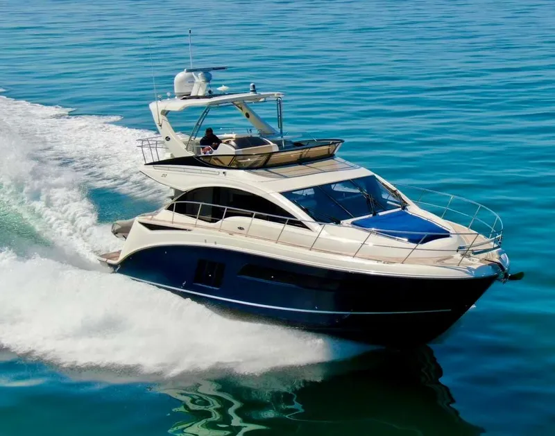 The Image of 2015 Sea Ray 510 Fly yacht cruising on open water. - 0