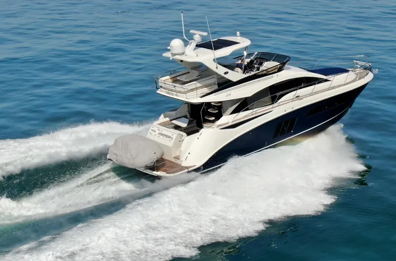 Slide: The Image of 2015 Sea Ray 510 Fly yacht cruising on open water. - 1