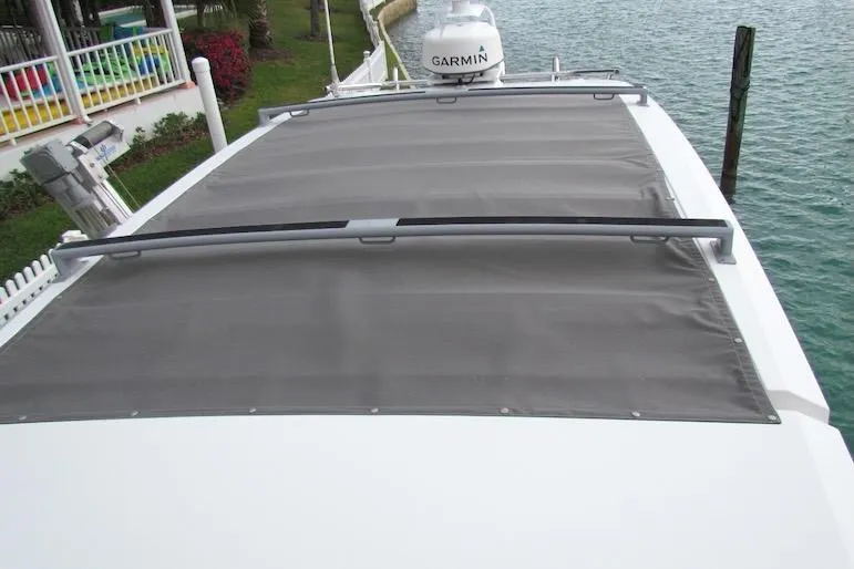 Slide: The Image of 2018 Axopar 37 Sun-Top boat with Garmin equipment, docked by the water. - 10