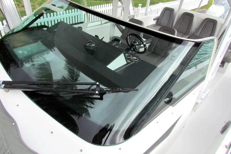 Slide: The Image of 2018 Axopar 37 Sun-Top boat cockpit with steering wheel and windshield view. - 11