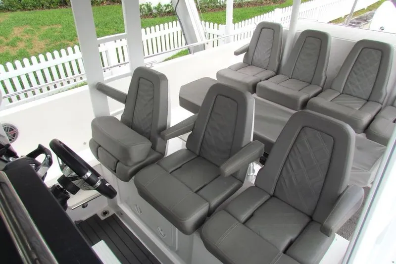 Slide: The Image of Interior seating of 2018 Axopar 37 Sun-Top boat with gray cushioned seats. - 14