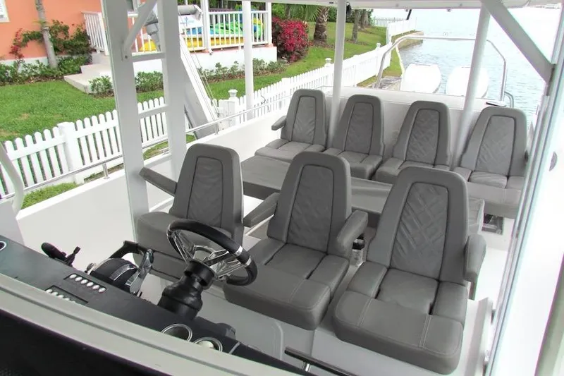 Slide: The Image of Interior of 2018 Axopar 37 Sun-Top boat with gray seating and steering wheel. - 15
